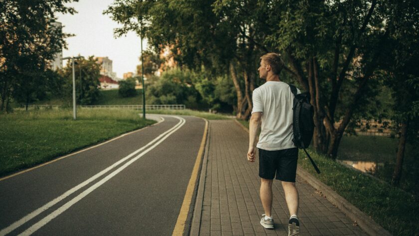 person walking on a road wearing supportive sneakers